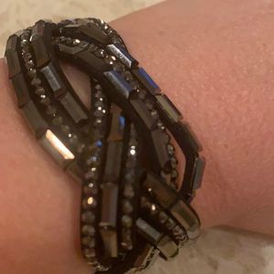 Black and pewter bracelet is adjustable with two snap closures.